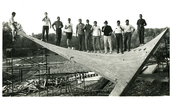 Students standing on the structure for a toast