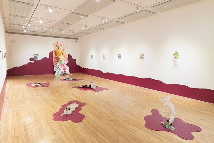 large room with ceramic sculpture and paintings arranged in it