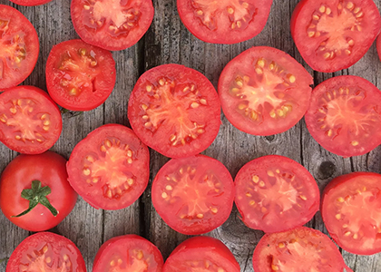table with many cut tomatoes