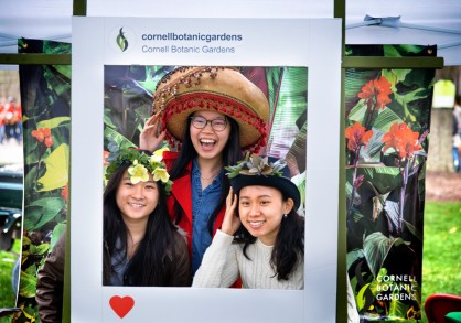 Two females standing in a photo booth getting their photo taken 
