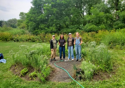 Women standing in a round garden