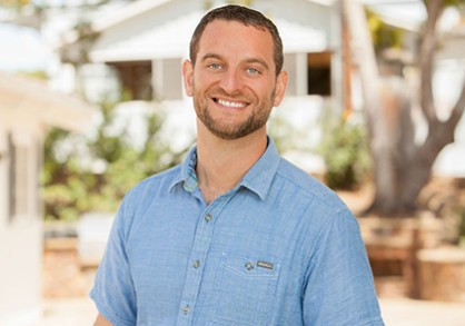 male with short brown hair and blue shirt
