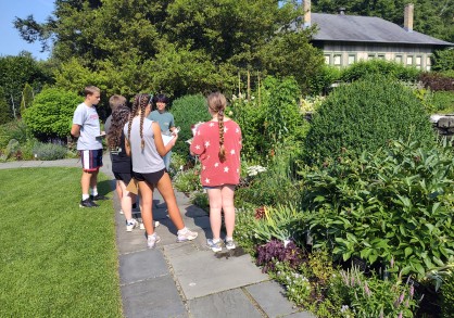 Joshua in Young Flower Garden with students
