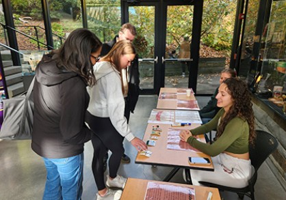 Student at table talking with visitors