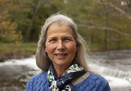 Woman standing by waterfall