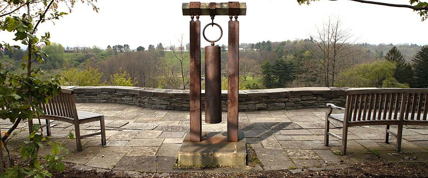 Overlook wtih a stone patio and walls with a large iron bell suspended in the middle