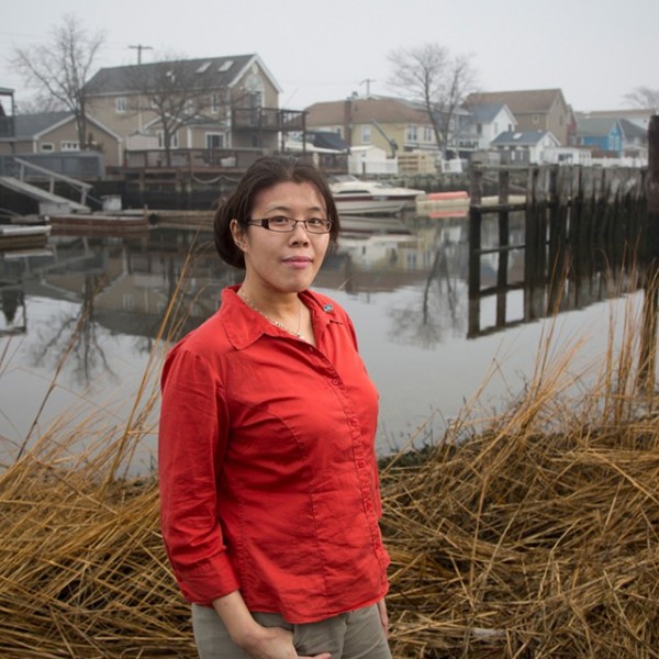 Helen Cheng stands near shoreline