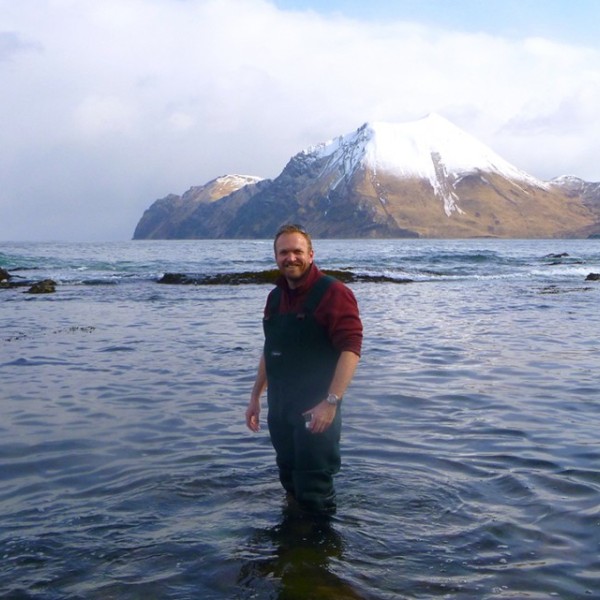 an Hewson standing in water in the Aleutian Islands, Alaska