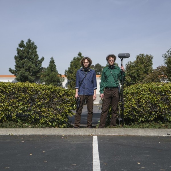 Chris Hoff and Sam Harnett standing with equipment