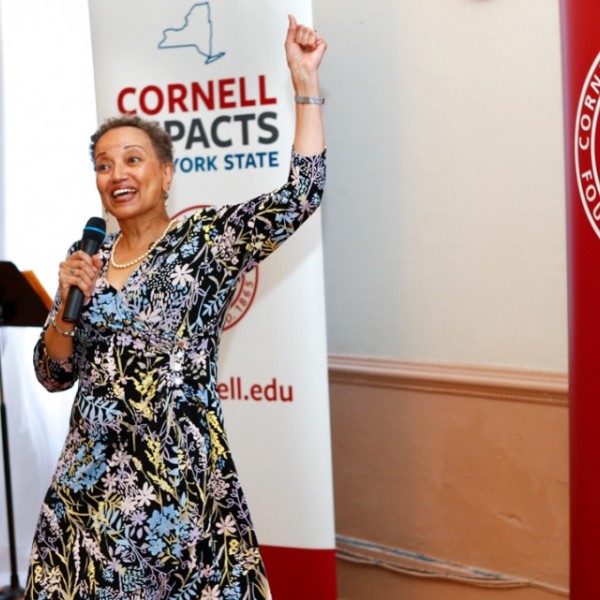 Jacqueline Davis-Manigaulte speaking, her arm raised