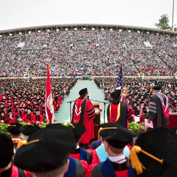 Students gather in a stadium for graduation