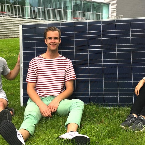 Students pose with a solar panel