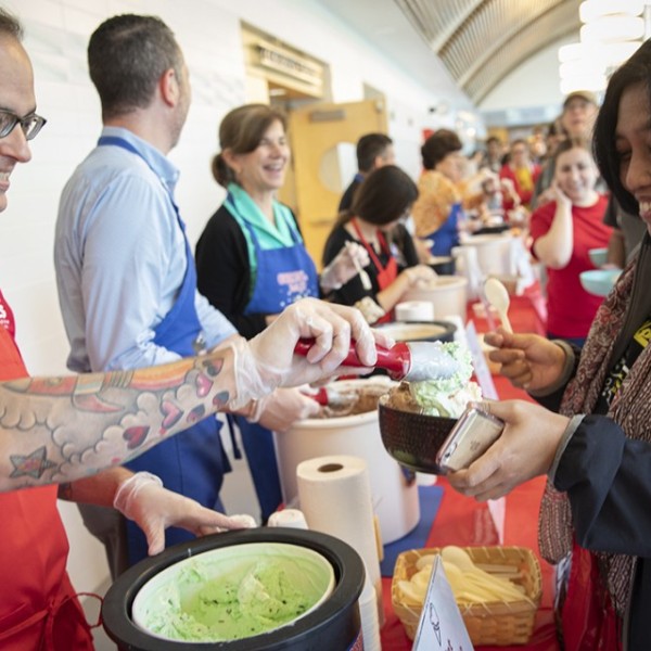 Volunteers serve ice cream to students