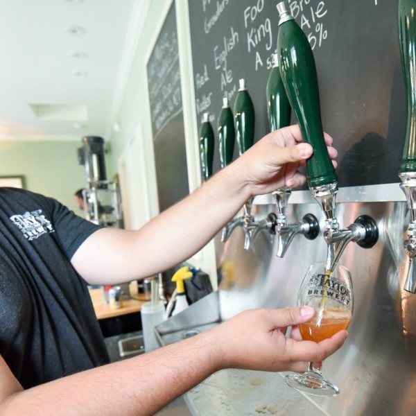 Man pours beer from a tap