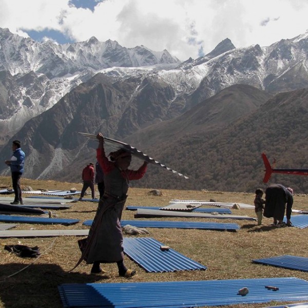 the people of Langtang carrying CGI sheets