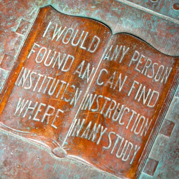 Cornell's motto carved in an image of a book