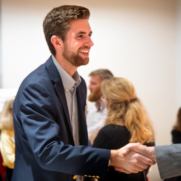 Intern shakes hands with employer