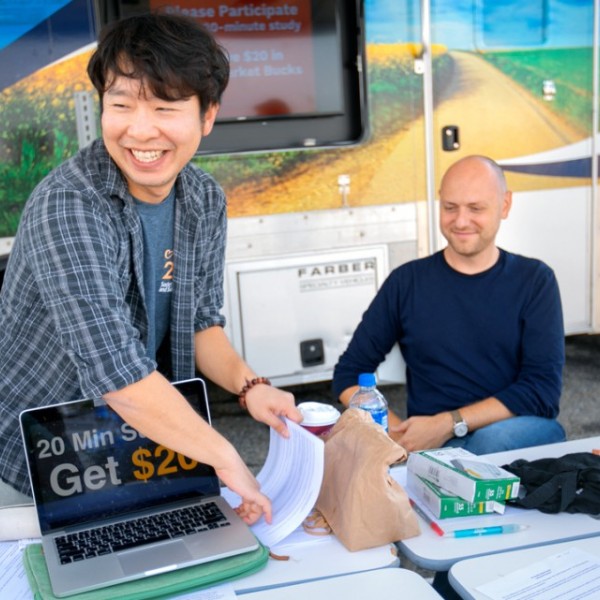 Students and Professors set up a table for a research study