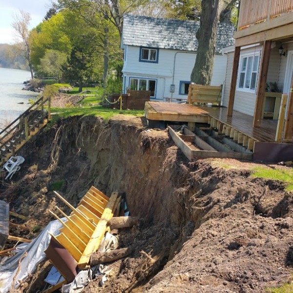 Houses at the edge of an eroding cliff