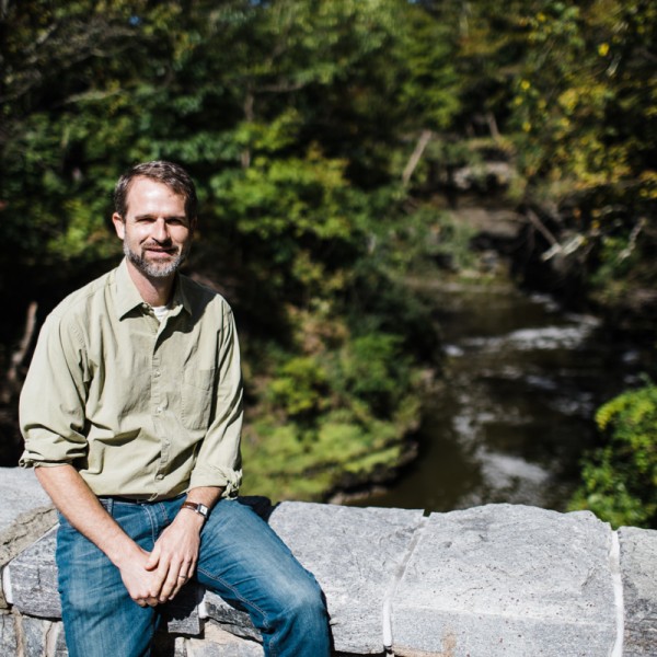 Pete McIntyre sitting on a stone bridge at Beebee Lake