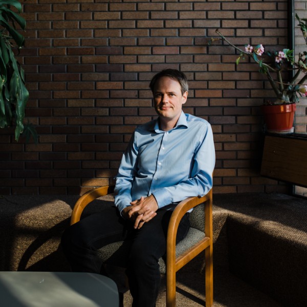 Peter Hitchcock sits in a chair on campus