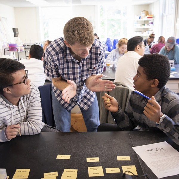 Professor working with students in lab