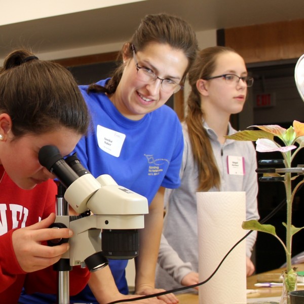 middle schoolers participating with microscope