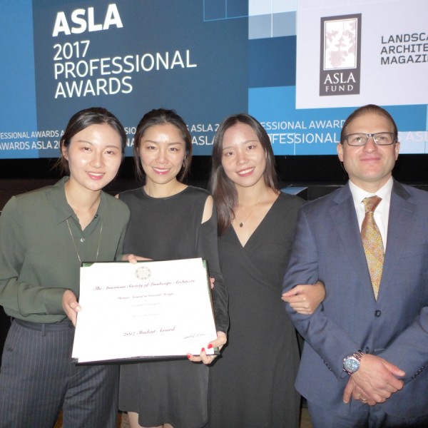 three students and a professor accept an award