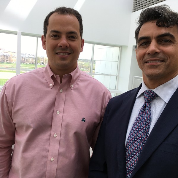 2 men standing and smiling