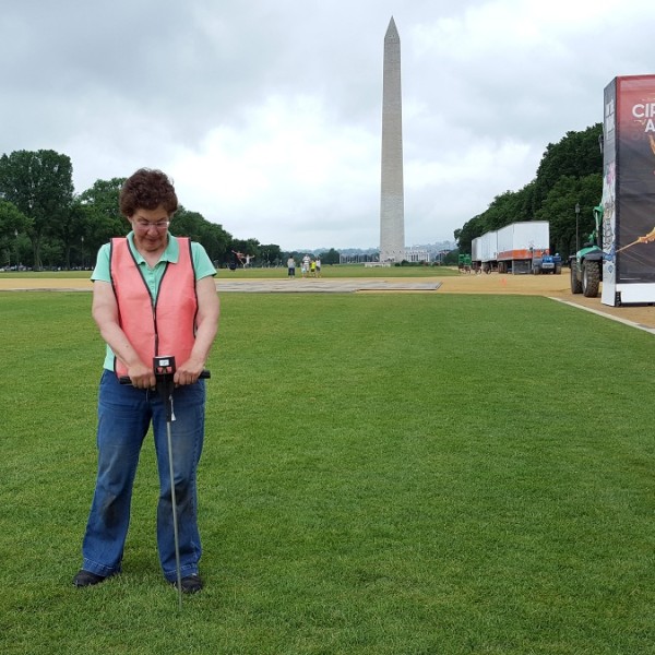 Researcher standing with the Washington Monument in the background