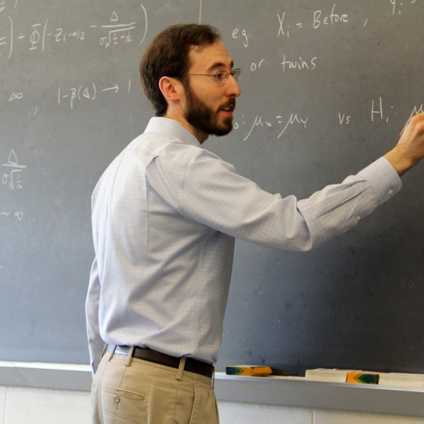 Jacob Bien writing on chalk board