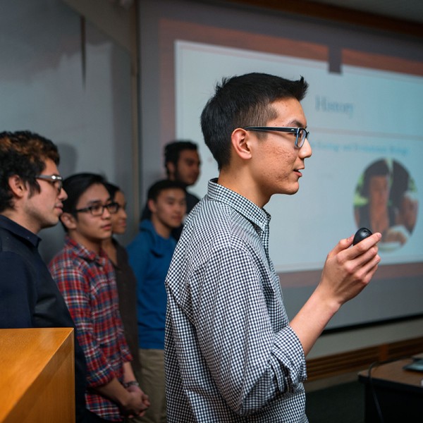 students with glasses deliver a presentation