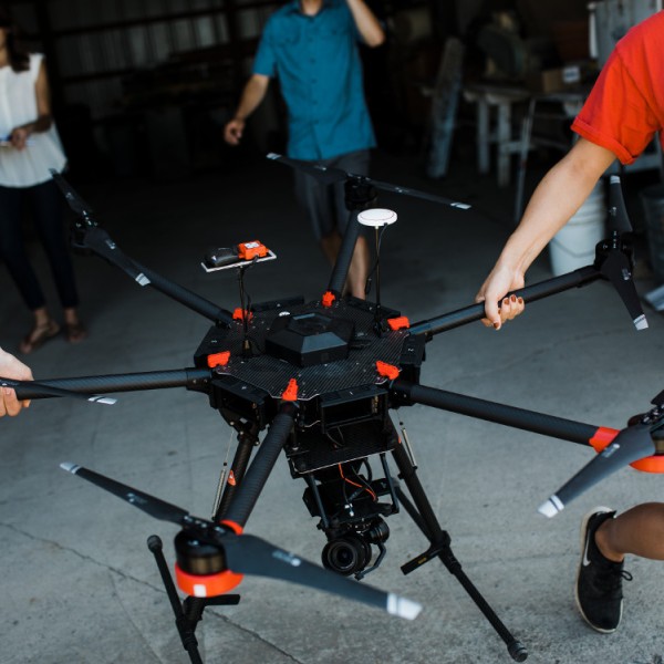 Students carrying a drone