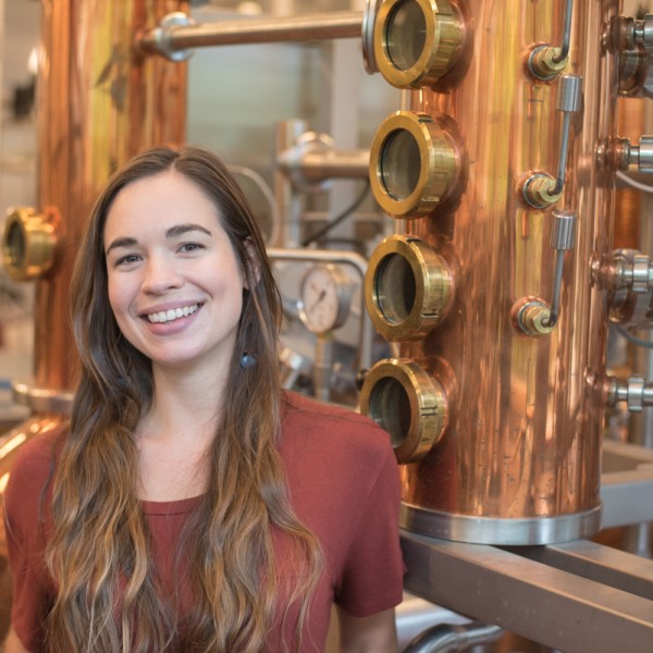 Kaylyn Kirkpatrick stands in front of equipment