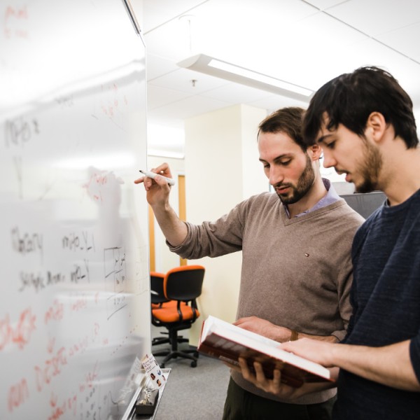 Students writing on a white board