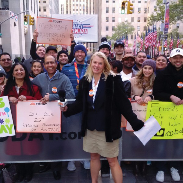 Jessica Ettinger Gottesman stands in front of a crowd with signs
