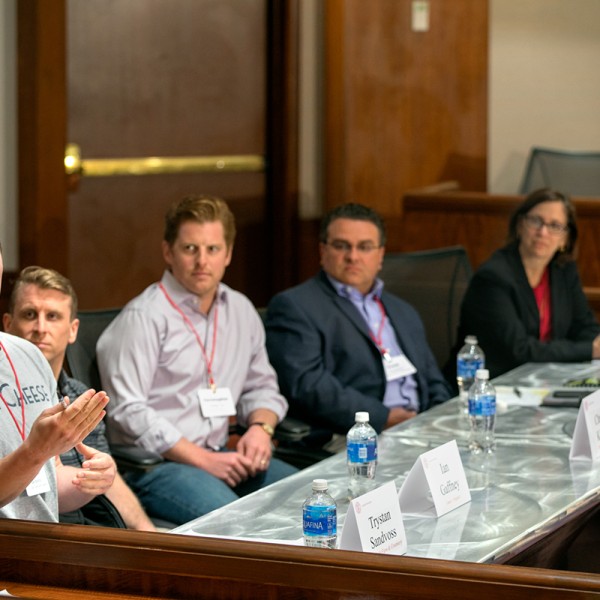 researcher speaks at panel while others listen