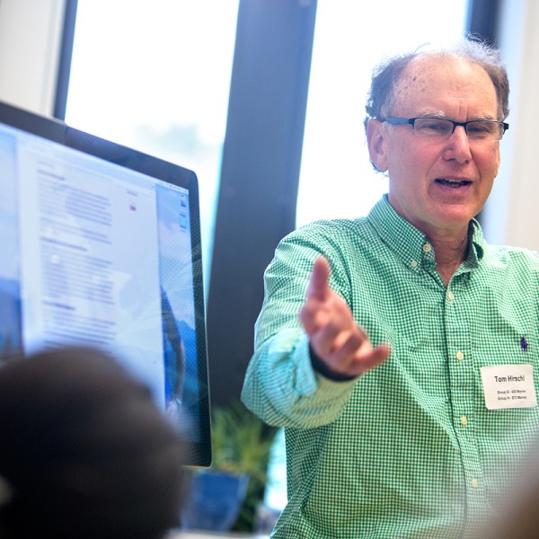 Tom Hirschl demonstrating his poverty calculator to other team members