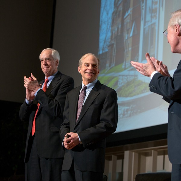 men on stage presenting