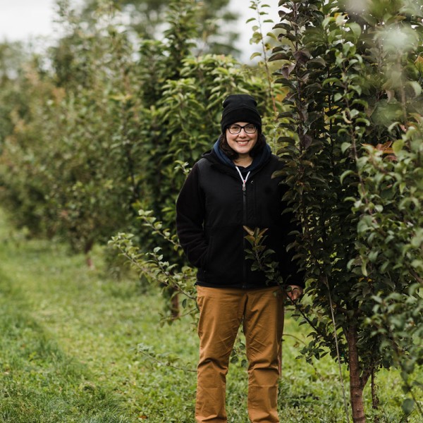 Laura Dougherty posing in apple orchard