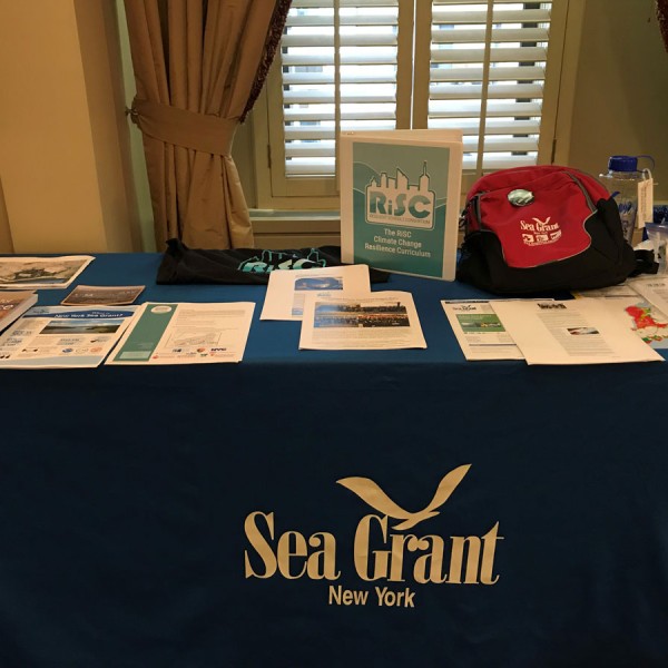 Outreach materials from New York Sea Grant stacked on a table