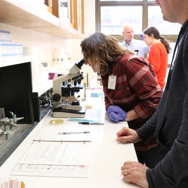 Patricia Brooks examines yeast under a microscope