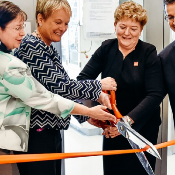 People cutting ribbon in ceremony