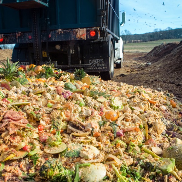 A truck dumps Cornell dining hall food waste at the university’s composting facility