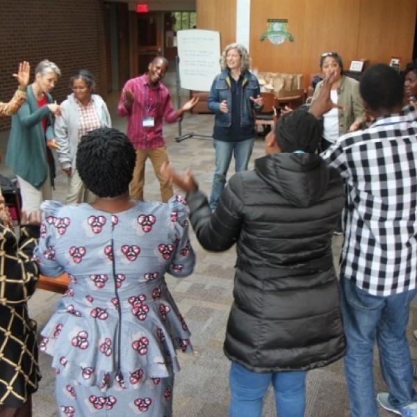 Members of the collaboratory dance in a circle