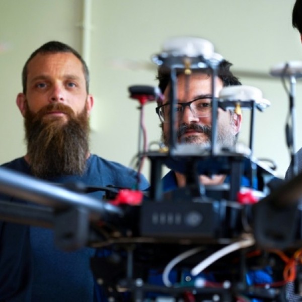 A drone appears in front of four male researchers