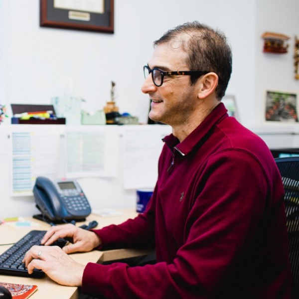 A man sitting at a computer typing