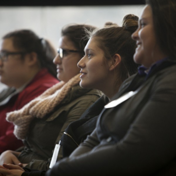 A group of people sit in a crowd