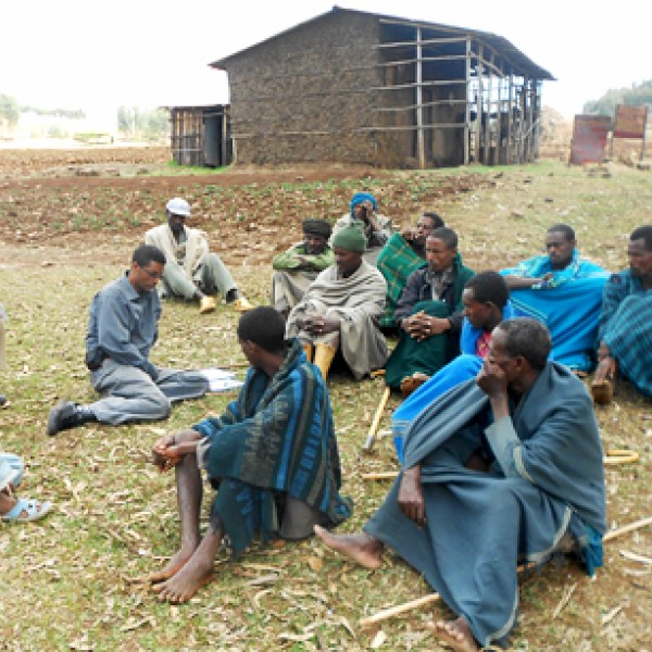 A group of people sit on the ground