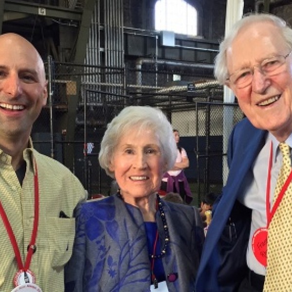 Two men and a woman stand together for a photo